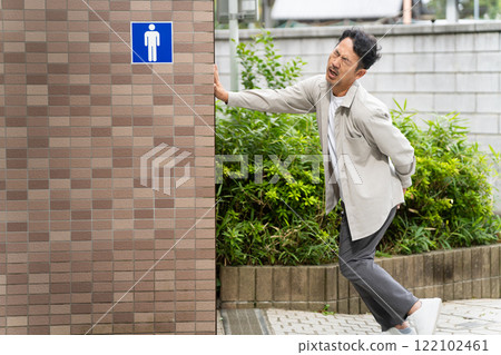 Middle-aged man entering a public toilet Lifestyle image Middle-aged man entering a public toilet Lifestyle image 122102461