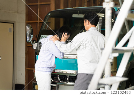 Middle-aged man and woman posing in front of a truck Construction image Middle-aged man and woman posing in front of a truck Construction image 122102493