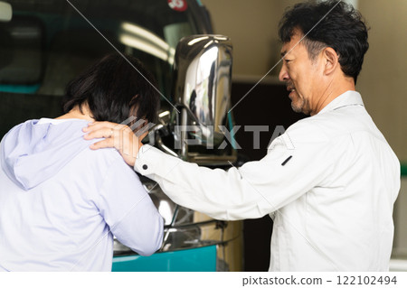 Middle-aged man and woman posing in front of a truck Construction image 122102494