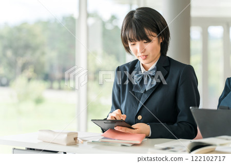 Junior high and high school girls studying using tablet devices 122102717