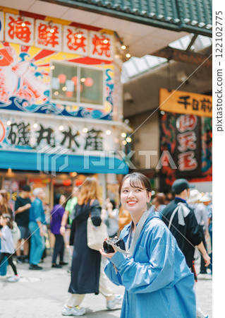 Camera girl taking photos of the streets of Osaka | Female photographer Camera girl taking photos of the streets of Osaka | Female photographer 122102775