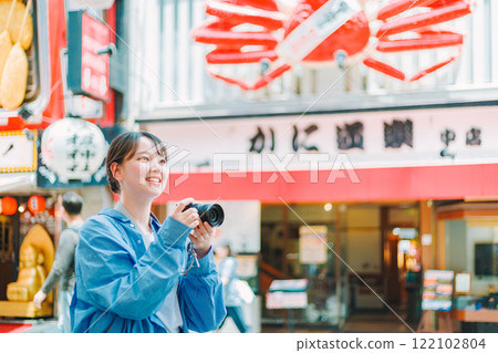 Camera girl taking photos of the streets of Osaka | Female photographer Camera girl taking photos of the streets of Osaka | Female photographer 122102804