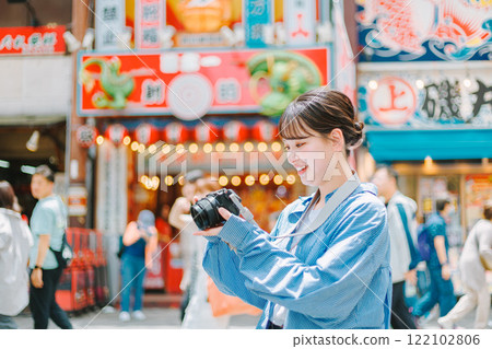 Camera girl taking photos of the streets of Osaka | Female photographer 122102806