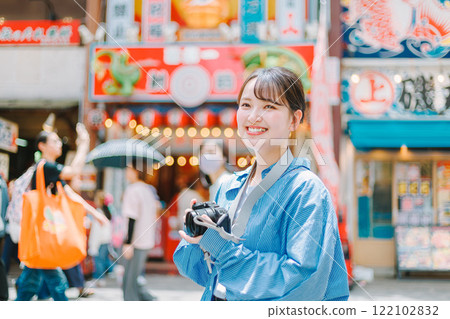 Camera girl taking photos of the streets of Osaka | Female photographer Camera girl taking photos of the streets of Osaka | Female photographer 122102832