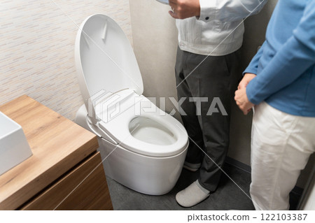 Repairman inspecting the toilet Lifestyle image 122103387