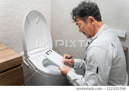 Repairman inspecting the toilet Lifestyle image Repairman inspecting the toilet Lifestyle image 122103396