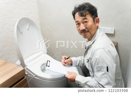 Repairman inspecting the toilet Lifestyle image 122103398