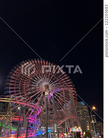 Colorful night view with a Ferris wheel Colorful night view with a Ferris wheel 122103683