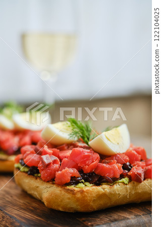 Delicious open-faced sandwich topped with fresh salmon and boiled egg 122104025