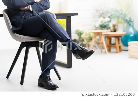 Middle-aged man with arms folded Business image 122105206