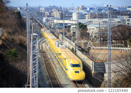 Doctor Yellow (T4 train) heading east with Fukuoka city in the background Doctor Yellow (T4 train) heading east with Fukuoka city in the background 122105480