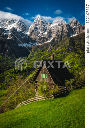 Lonely cute wooden hut on the slope, Julian Alps, Slovenia Lonely cute wooden hut on the slope, Julian Alps, Slovenia 122107817