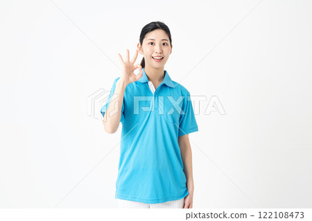 A young woman working as a caregiver giving an OK sign 122108473