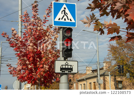 Traffic lights red color for pedestrians and autumn trees on background 122108573
