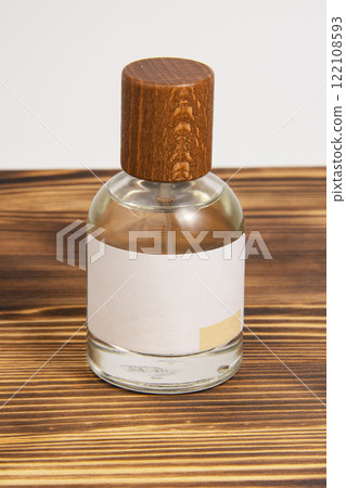 Perfume bottle on dark wooden background woody scent with copy space for text Perfume bottle on dark wooden background woody scent with copy space for text 122108593