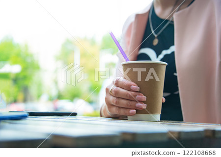 Paper coffee cup aromatic in woman hand 122108668