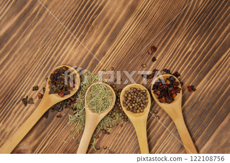 Aroma wooden spoon with different dry spices on natural wooden background Aroma wooden spoon with different dry spices on natural wooden background 122108756