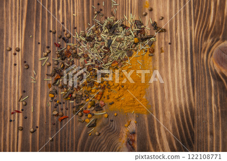 Dried different spices on wooden texture background Dried different spices on wooden texture background 122108771