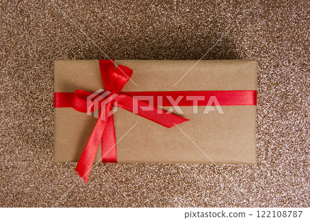 Craft gift box with red bow on shiny background 122108787