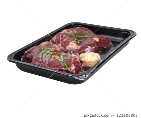 Fresh meat pork steak with garlic, rosemary in vacuum black pack isolated on the white background 122108802