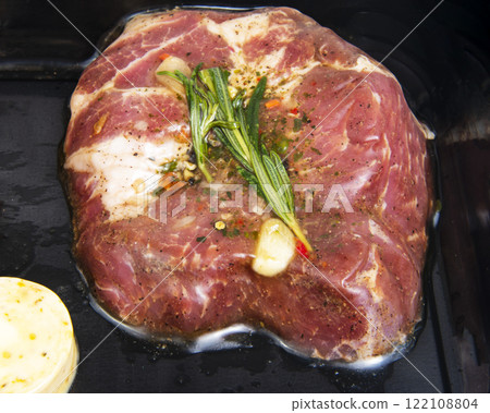 Fresh meat pork with garlic, rosemary in vacuum black pack 122108804