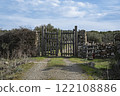 Rustic wooden gate with dry stone wall in a rural countryside 122108886