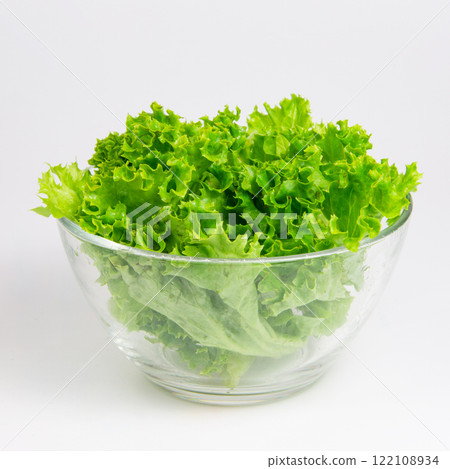Green fresh salad of lettuce in glass dish on the white background Green fresh salad of lettuce in glass dish on the white background 122108934