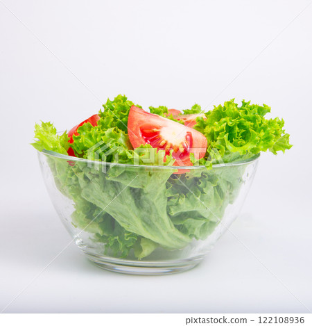 Green fresh salad of lettuce in glass dish on the white background Green fresh salad of lettuce in glass dish on the white background 122108936