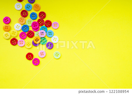 Cloth buttons on the yellow background with copyspace 122108954