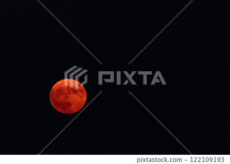 Orange-Tinted Full Moon in the Emptiness of a Black Sky Orange-Tinted Full Moon in the Emptiness of a Black Sky 122109193