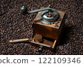 Rustic coffee grinder with a measuring spoon on a background of lots of coffee beans 122109346