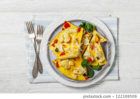 cauliflower, zucchini and red bell pepper frittata cauliflower, zucchini and red bell pepper frittata 122109509