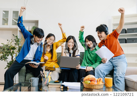 Happy group of college students use laptop feel excited overjoyed triumph with good news over smartphone or Tablet. Happy group of college students use laptop feel excited overjoyed triumph with good news over smartphone or Tablet. 122109721