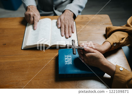 Men and women praying to God with the Bible, seeking blessings and guidance.  heartfelt depiction of faith, devotion, and spiritual connection. 122109871
