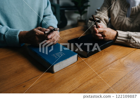 Men and women praying to God with the Bible, seeking blessings and guidance. heartfelt depiction of faith, devotion, and spiritual connection. Men and women praying to God with the Bible, seeking blessings and guidance. heartfelt depiction of faith, devotion, and spiritual connection. 122109887