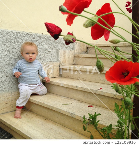 little girl on the steps of a porch 122109936