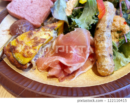 Morning plate of prosciutto, sausage and salad 122110415