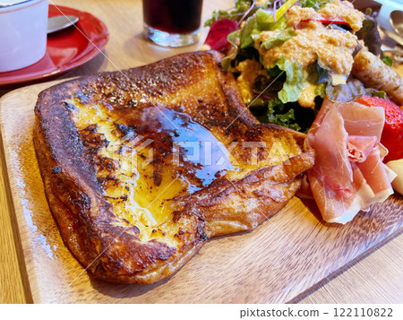 A breakfast plate with French toast and salad, featuring plenty of egg batter. A breakfast plate with French toast and salad, featuring plenty of egg batter. 122110822