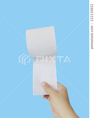 Hand Holding a Roll of Toilet Paper on blue background 122110852