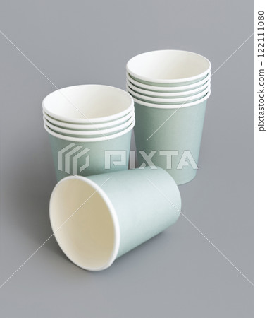 Light green paper disposable cup closeup on grey. Eco friendly, zero plastic tableware 122111080