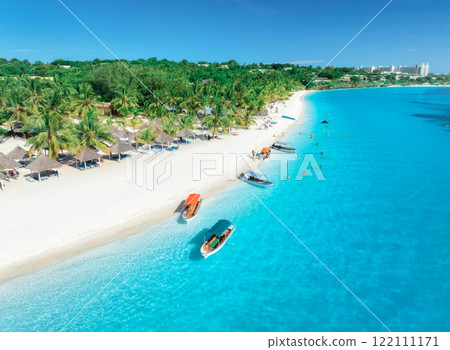 Aerial drone view of boats and sea coast with white sandy beach 122111171