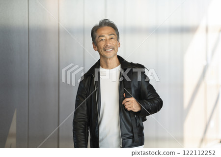 A man in his 60s smiling at the camera 122112252