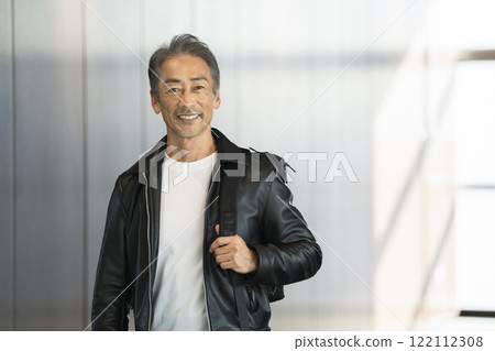 A man in his 60s smiling at the camera A man in his 60s smiling at the camera 122112308
