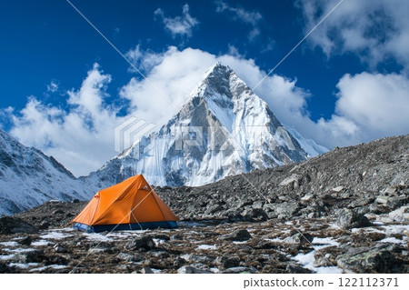 Tourist tent on the background of a mountain peak. 122112371