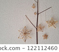 Scandinavian handicraft Himmeli, handmade from natural rye straw, laid out on tree branches 122112460