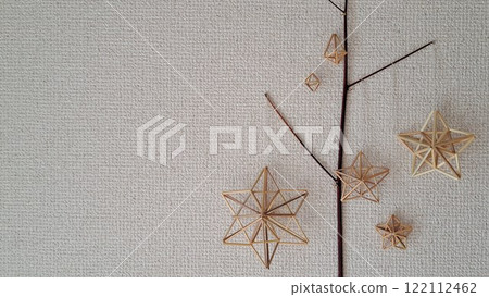 Scandinavian handicraft Himmeli, handmade from natural rye straw, laid out on tree branches 122112462