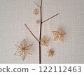 Scandinavian handicraft Himmeli, handmade from natural rye straw, laid out on tree branches 122112463