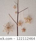 Scandinavian handicraft Himmeli, handmade from natural rye straw, laid out on tree branches 122112464