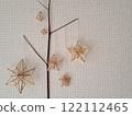 Scandinavian handicraft Himmeli, handmade from natural rye straw, laid out on tree branches 122112465