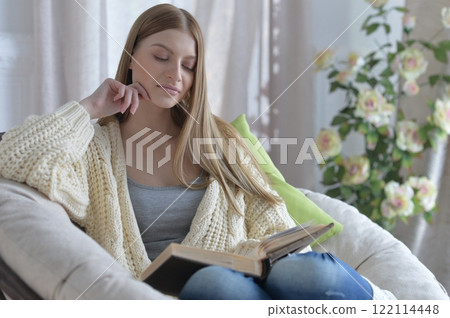 Portrait of young woman in pajamas on bed with fluffy plaid Portrait of young woman in pajamas on bed with fluffy plaid 122114448